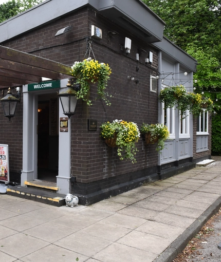 Exterior beer garden of a pub with a seating area.