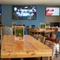 The interior restaurant and seating area with TV at the Woodlands Edge.