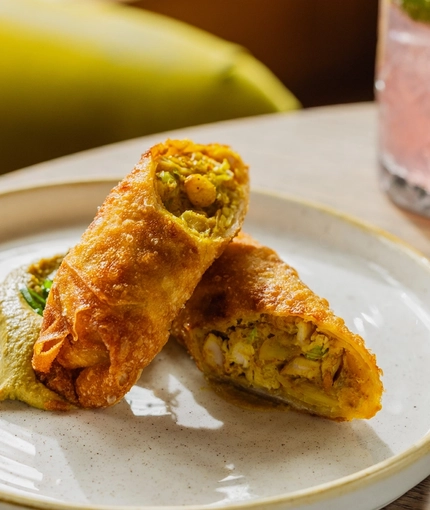 Smoked chicken spring rolls served on a small plate at Crafted Venues.
