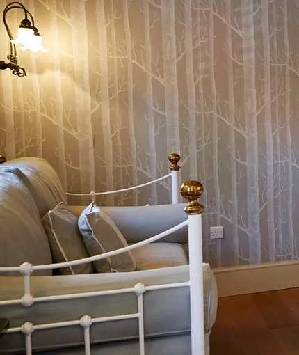 The interior hotel double bedroom with double bed and TV and a sofa at the Fox.