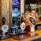 A close up view of the bar inside The Bramford Arms in Woodsetton, with a TV on the wall above the counter.