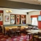 Interior dining area of a pub with a TV.