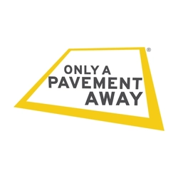Yellow slanted geometric logo with the words ‘Only a Pavement Away’ in bold, dark-grey capital letters. The text is centred on the angled yellow shape, which resembles a tilted street sign with a white drop shadow behind it.