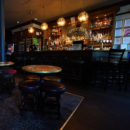 The interior bar and seating area with fireplace at The Tappit Hen.