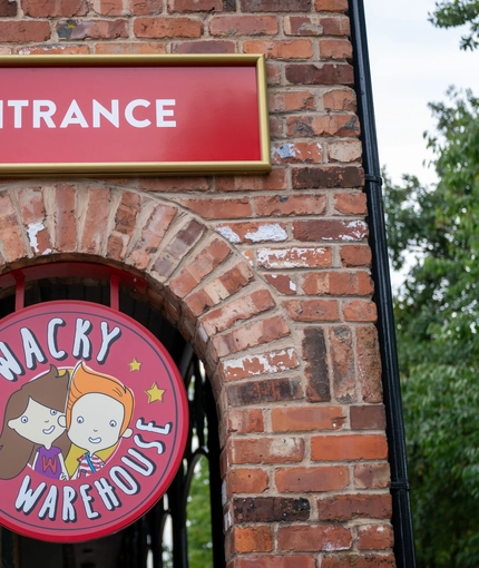 A close up view of the exterior signage of the Wacky Warehouse at The Stanley Ferry.