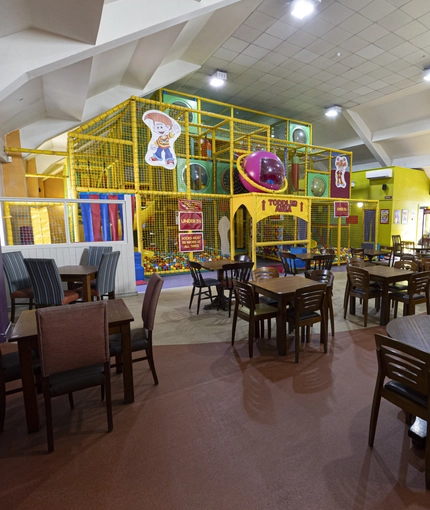 interior restaurant and seating area with a play area