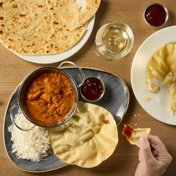 A graphic banner advertising curry night tikka platter at Hungry Horse venues 