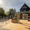 An image of the exterior facade and car park with beer garden seating area at The Old Red Lion.