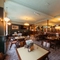The interior restaurant seating area at the Lord Raglan in Holborn, with framed artwork and a TV on the wall.