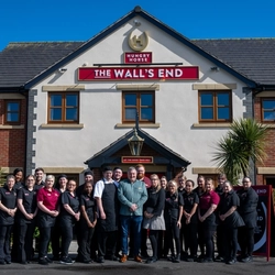 The members of staff of The Wall's End in Wallsend, standing outside in front of the entrance to the pub.