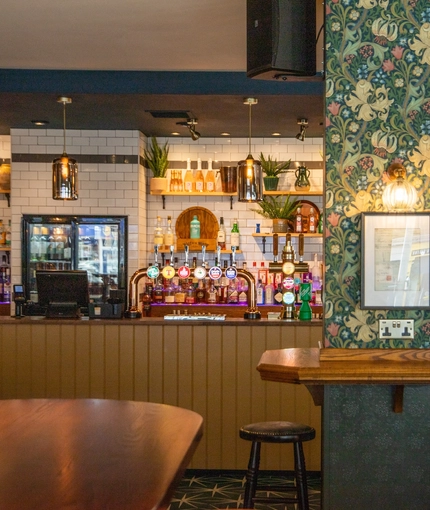 The bar and interior seating area of The Merlin in Edinburgh.