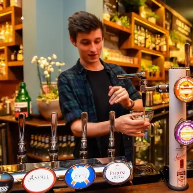 Metro - Grove (Surbiton) - A team member pours a pint at the bar