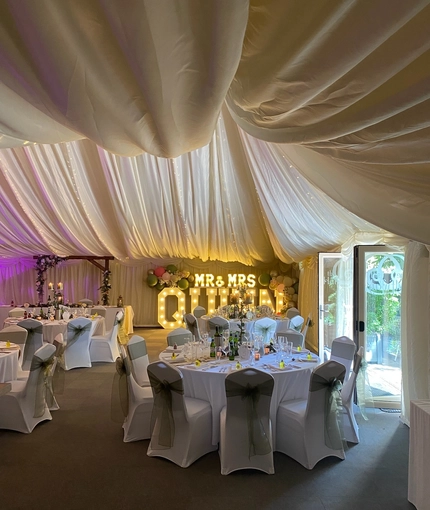 A marquee, decorated for a wedding.