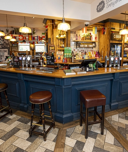 Interior bar area of a pub with a seating area.