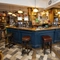 Interior bar area of a pub with a seating area.