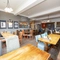 Interior dining area of a pub with a TV.