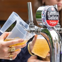 An image focusing on a pint of lager being poured by a member of staff stood behind the exterior bar during The Boat Race event at The Crabtree.