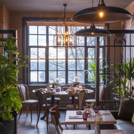 Restaurant area with tables set up in front of the large window