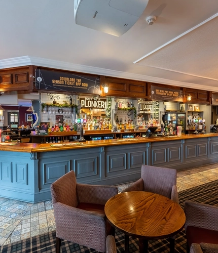 Interior dining area of a pub with a bar.