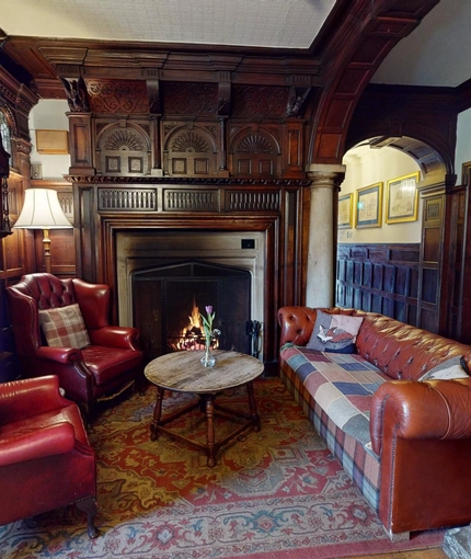 A seating area and fireplace inside The Rothley Court Hotel.