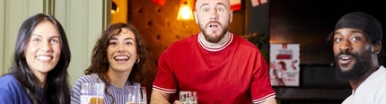 A mixed group of people, sitting at an indoor table reacting to sport event.