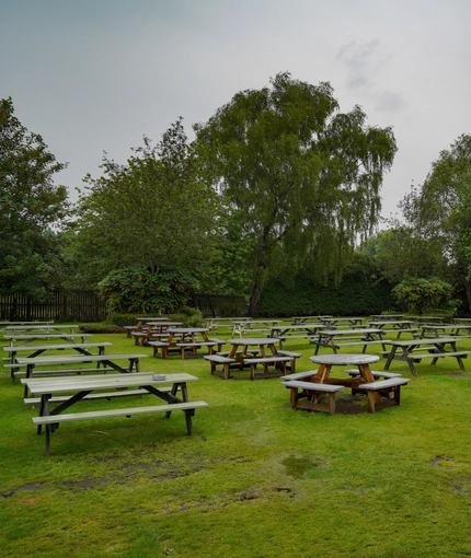 Exterior beer garden of a pub with a seating area.