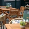 The exterior patio beer garden seating area with tables, chairs and scatter cushions at The Watergates Bar.