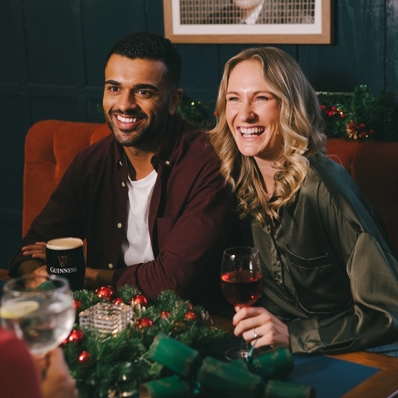 An image of 3 friends sat within the interior seating area with various drinks.