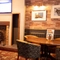 The interior restaurant and seating area with TV and fireplace at the Kingstown Hotel.