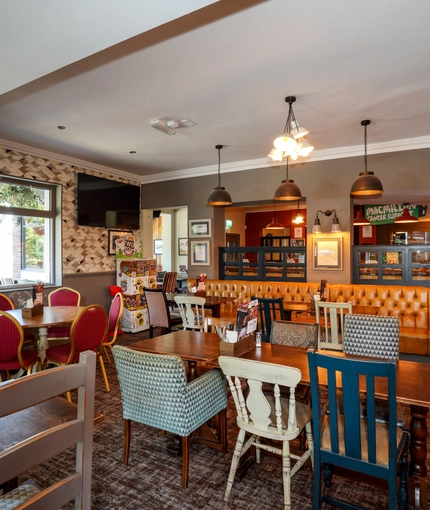 Interior dining area of a pub with a TV.