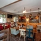 Interior dining area of a pub with a TV.