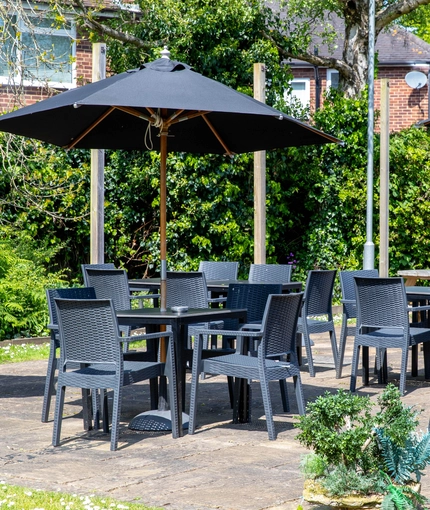 Exterior beer garden of a pub with a seating area.