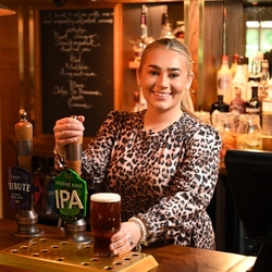 Team member pouring a pint