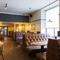 Interior dining area of a pub with TVs.