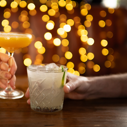 a man and a woman holding cocktails