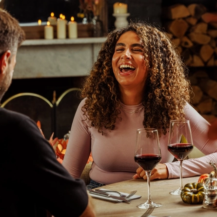 An image of 2 people enjoying red wine within the interior restaurant and seating area at The Foundry Bell.