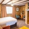 A suite bedroom with a sofa and coffee table at The Red Lion, Adderbury.