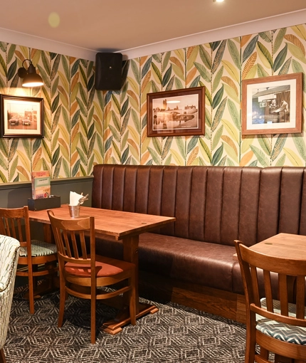 Interior corner seating area with brown sofas