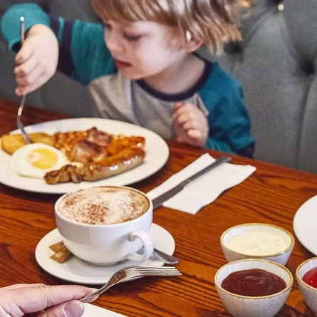 A family enjoying breakfast at a Pub & Carvery restaurant