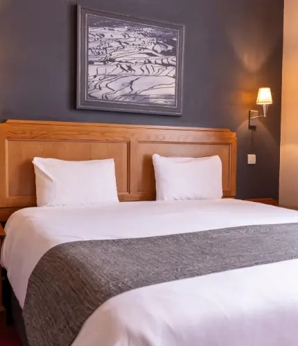 The interior hotel king bed bedroom at the Brentwood.