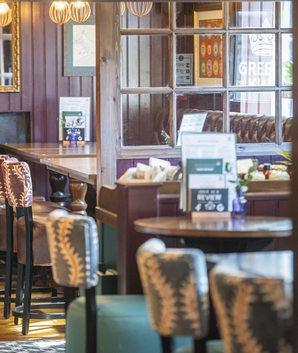 The interior restaurant and seating area with log burner at The Bell.