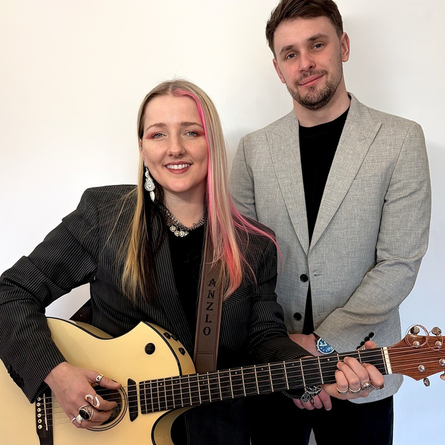 A image of two performers posing for the camera, one is holding a guitar, used to advertise 'whats on' in Crafted venues.