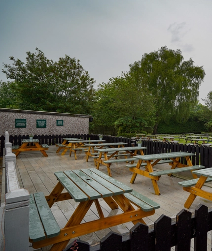 Exterior beer garden of a pub with a seating area.