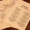 An image of a collection of printed poems and songs sat on a table within the interior function room during a Burns Night Event at The Crabtree.