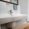 The interior hotel bathroom with bath, toilet and sink at The Commodore.