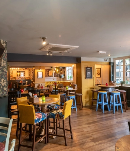 Interior dining area of a pub with a TV.