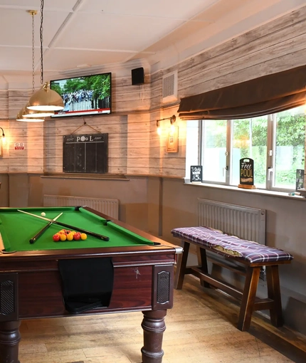 Pool table and TV in interior games area