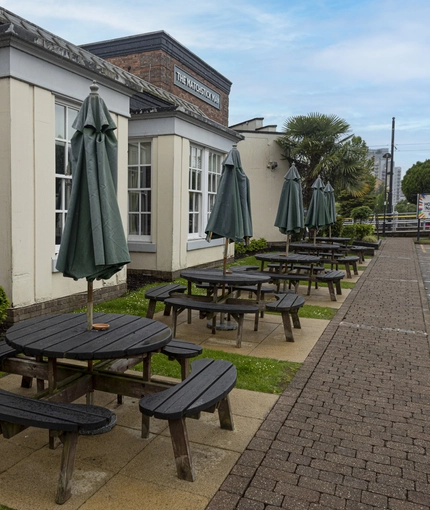 Exterior beer garden of a pub with a seating area.