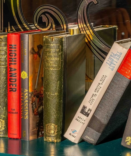 A close up image focusing on a collection of books sat on a shelf at The Lucas Arms.