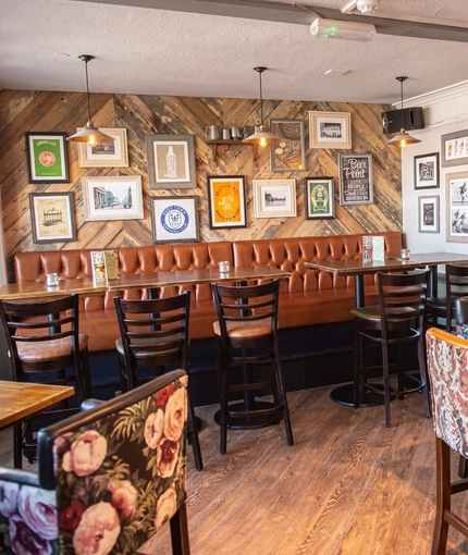 The interior restaurant seating area with electronic pub game at The Spread Eagle.